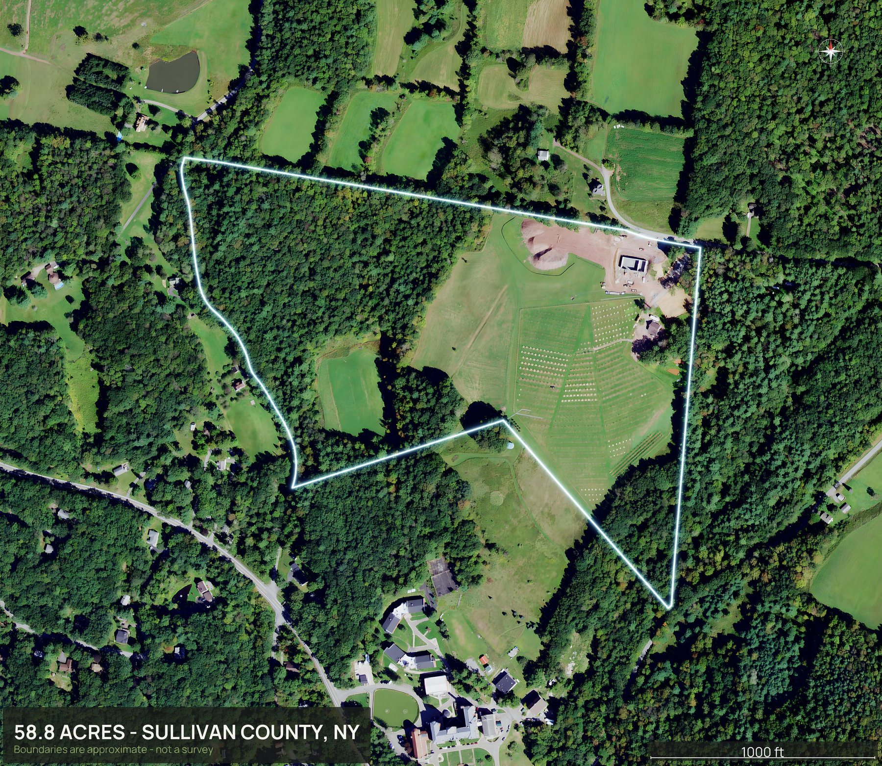 Outlined top down aerial photo of a New York land parcel with the boundary drawn in green